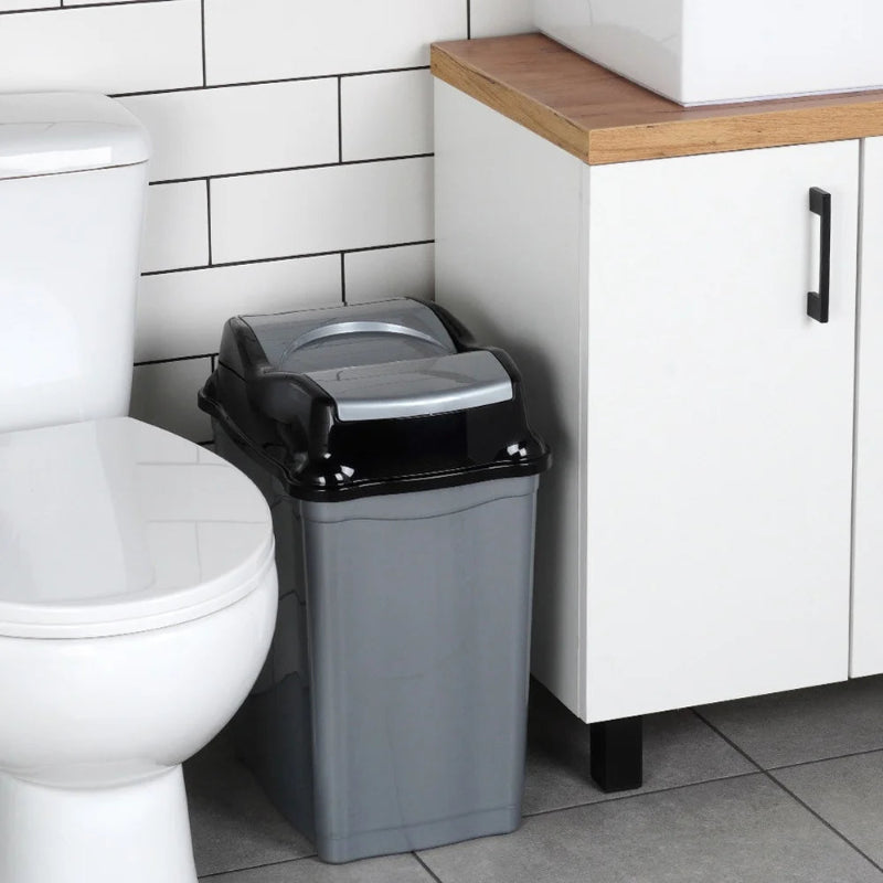 La Poubelle de bureau en plastique 28L à côté d'un meuble